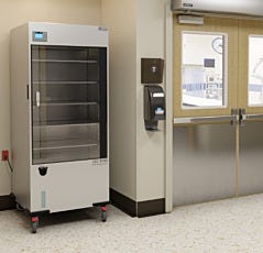 A large aluminum-body sterile storage cabinet in use in a hospital setting