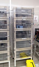 Tall desiccator cabinets on stands for storing photonics and laser components