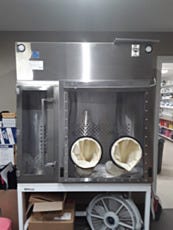 USP 797 capable stainless steel compounding pharmacy glovebox on a workbench