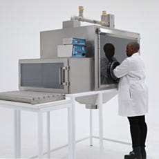 Nitrogen purged and ULPA filtered SS glovebox isolator with rollers and funnel to empty heavy bags