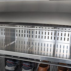Open shoe rack compartment showcasing perforated dividers