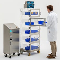 full view of scientist putting items into a nitrogen desiccator cabinet