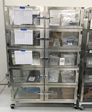 A 10-chamber desiccator cabinet on wheels, filled with small electronics parts