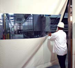 worker pulling roll up door to the side