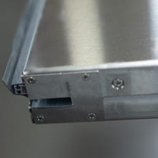 Close-up of automatic sliding door top track and wheel assembly