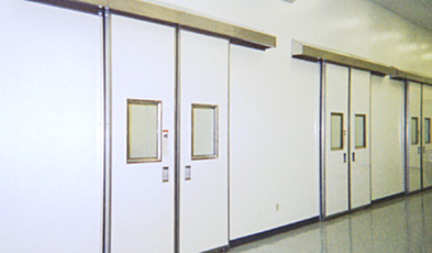 Single sliding cleanroom door with fiberglass panel and stainless steel hardware in a real setting