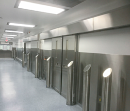 Single sliding cleanroom door with stainless steel panel and hardware in real setting