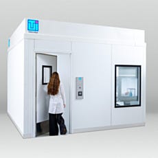 Researcher entering BioSafe cleanroom anteroom rear view