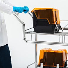 close up of technician transporting wafer boxes in a round tube cleanroom cart
