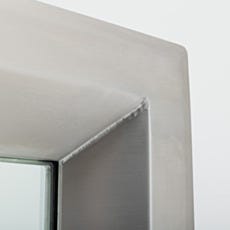 Stainless steel continuous-welded seam on center-mount cleanroom window corner