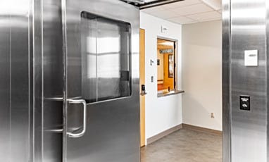 Cleanroom entry with stainless steel door and medical treatment area window