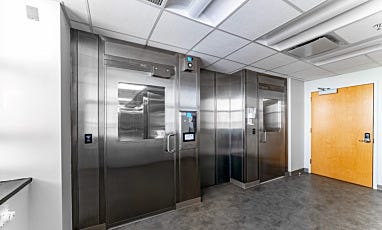 Cleanroom gowning or entry vestibule with stainless steel doors