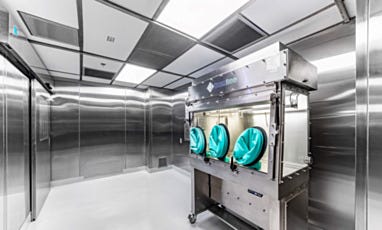Hazardous cleanroom with isolator for sterile compounding