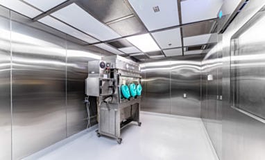 Hazardous cleanroom with stainless steel isolator unit and glove ports