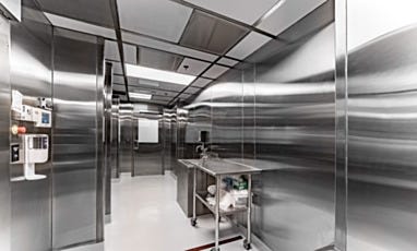 Cleanroom interior with stainless steel walls, sink, and workstation