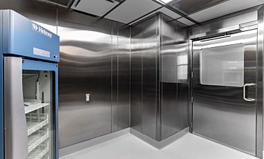 Cleanroom with stainless steel walls and laboratory refrigerator