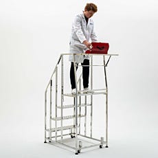 scientist at top of 4 step mobile step ladder with toolbox resting on custom shelf