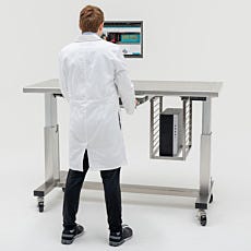 Lab technician standing at the automatic adjustable workstation