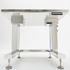 Underside of stainless steel work station with bull-nose rounded table top and blue leveling feet