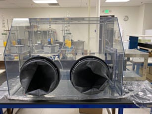plastic single user glovebox isolator with airlock on a workbench
