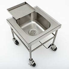 Overhead view of a stainless steel soak sink with a raised edge and tray