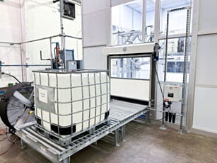 white high speed roll up door with converyor belt leading to it