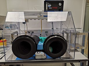 Inert gas glove box isolator for cooling surfaces with liquid nitrogen