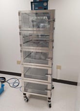 A mobile desiccator cabinet with automatic nitrogen gas purge for storing semiconductor wafers