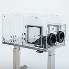 Isolator glovebox with pass-through door and glove ports