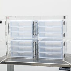 Desiccator four-chamber doors are open with one drawer inside each