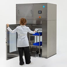 Model pushing a cart in the stainless steel air shower pass-through