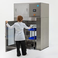 Model pushing a cart in the stainless steel air shower pass-through