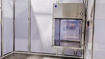 Stainless steel pass-through chamber installed in cleanroom interior wall