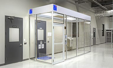 Installed modular cleanroom with acrylic panels, steel frame, and control panel