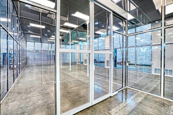 Swing door transition between gowning area and main cleanroom in hardwall modular cleanroom