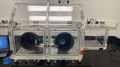 Negative pressure exhaust glovebox with right-side airlock