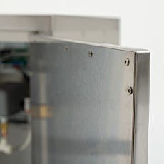 Close-up of stainless steel nitrogen generator cabinet with fasteners
