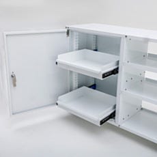 Close-up of two pull-out sliding shelves fully extended from the lockable compartment of an under counter multifunctional storage cabinet