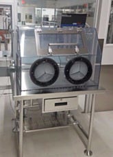 Clear custom polycarbonate glovebox, on perforated steel workstation