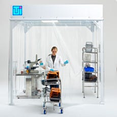 Laboratory Technician Inside Softwall Cleanroom with Mobile Equipment Cart