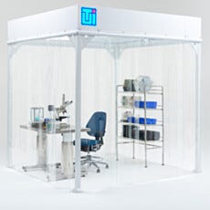 Softwall cleanroom enclosure with clear vinyl curtains, workstation, microscope table, and storage shelving