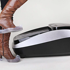 boot with film cover stepping off of automatic shoe cover