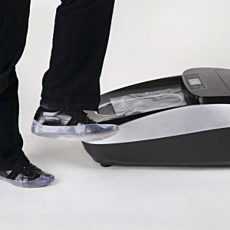 dress shoe with film cover stepping off of automatic shoe cover