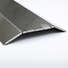 Detail shot of a stainless steel floor raceway highlighting the hem and knock-out slots