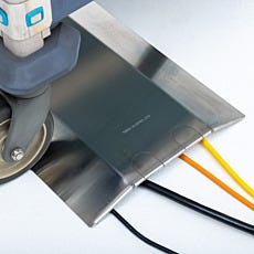 Stainless steel cable raceway with cord slots for cable management system.