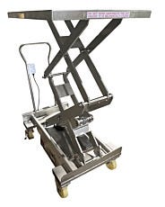 Stainless steel portable hydraulic scissor lift cart raised showing mechanism and safety warning