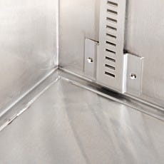 Close-up of fully welded bottom seam and shelving mount inside stainless steel storage cabinet for cleanroom applications.