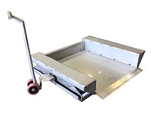 Stainless steel semi portable ground level lift lowered showing platform and tow handle