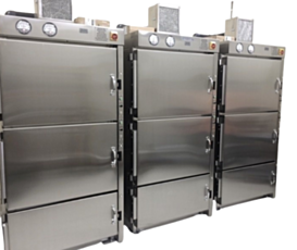 large stainless steel cabinets with three cells stacked sat in a row; lead-lined for nuclear pharmacy