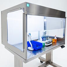 Laminar flow hood interior with pipette, balance, and flask